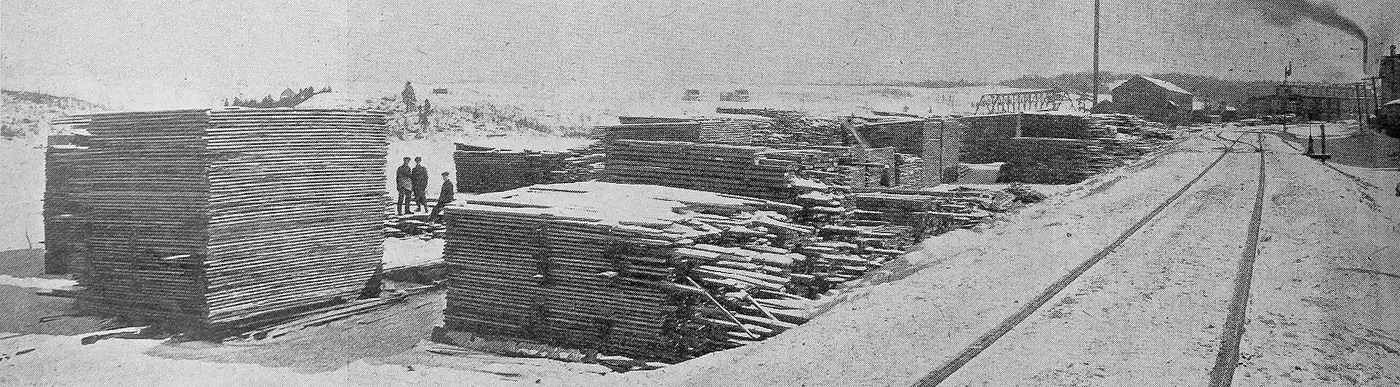 A hardwood lumber yard with stacked boards