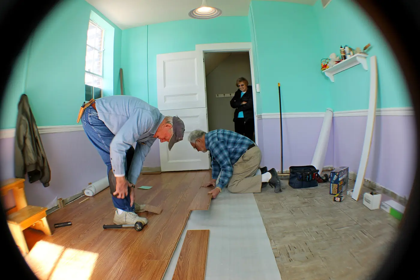 Laminate flooring planks being assembled, showing the manufactured surface