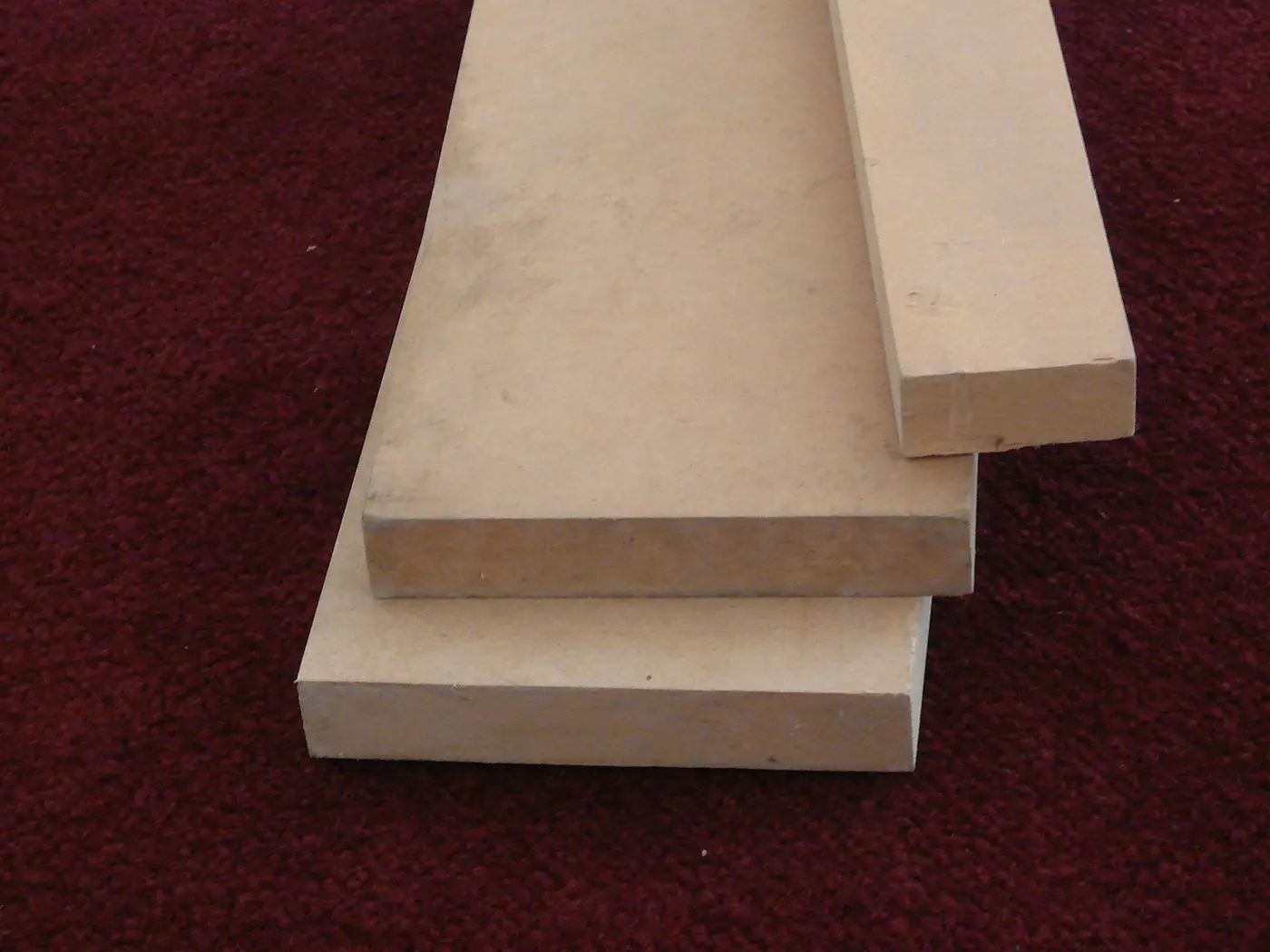 An MDF board sample showing its smooth, uniform fiber surface